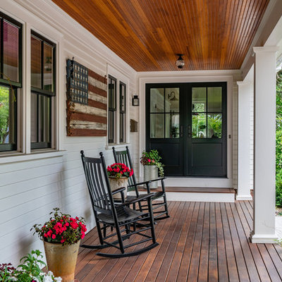 This is an example of a large country porch design in Boston with decking and a roof extension.