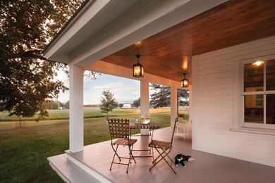 Farmhouse veranda in Other with a roof extension and feature lighting.