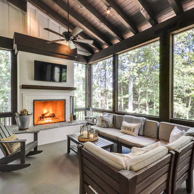 This is an example of a cottage screened-in porch design in Atlanta with decking and a roof extension.