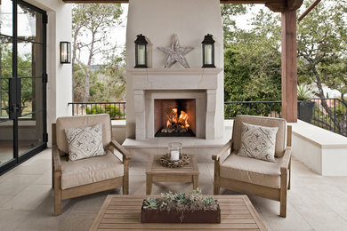 Tuscan porch idea in Austin with a fire pit