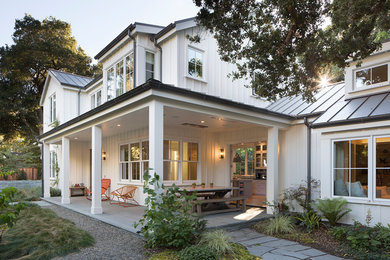 Mid-sized farmhouse stone side porch photo in San Francisco with a roof extension