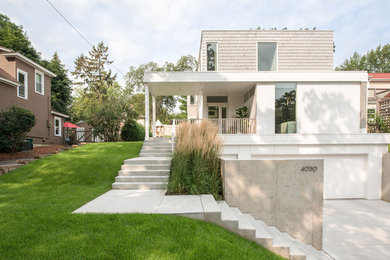 Inspiration for a mid-sized modern concrete front porch remodel in Minneapolis with a roof extension