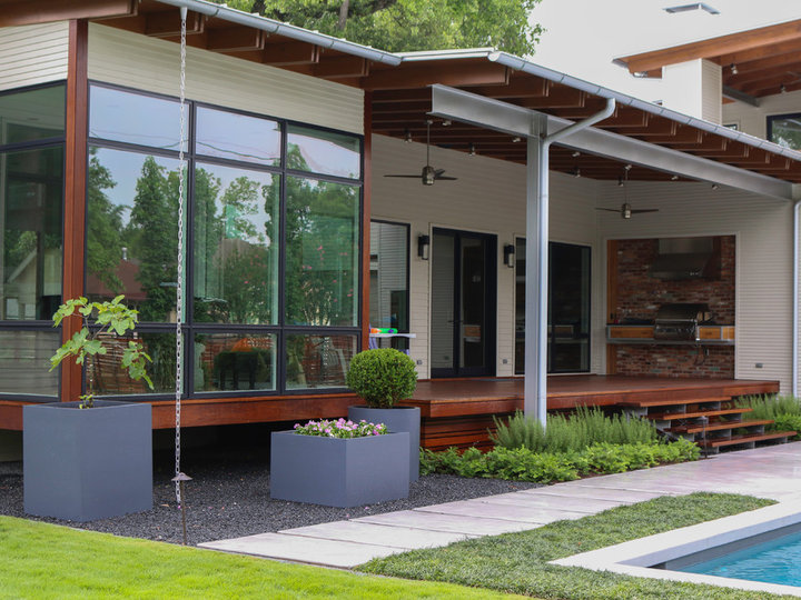Inspiration for a large modern concrete porch remodel with a roof extension