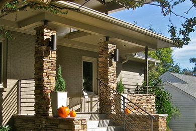 This is an example of a small contemporary front porch design in Atlanta.