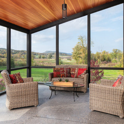 Inspiration for a mid-sized cottage concrete screened-in side porch remodel in Burlington with a roof extension