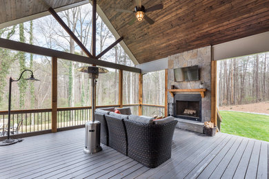 Large arts and crafts back porch idea in Atlanta with a fire pit, decking and a roof extension