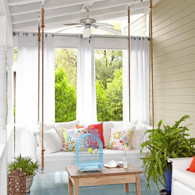 Cottage front porch idea in Los Angeles with decking and a roof extension