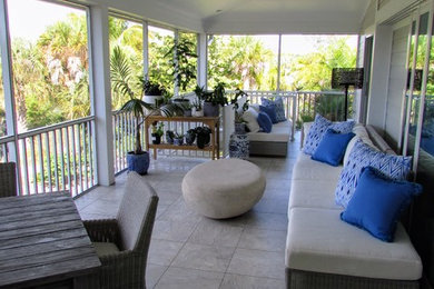 Mid-sized transitional tile screened-in back porch idea in Miami with a roof extension