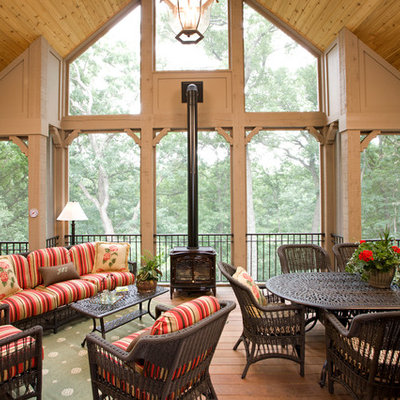 This is an example of a large traditional back porch design in Minneapolis with decking and a roof extension.