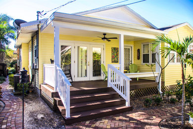 Inspiration for a large craftsman front porch remodel in Tampa with decking and a roof extension
