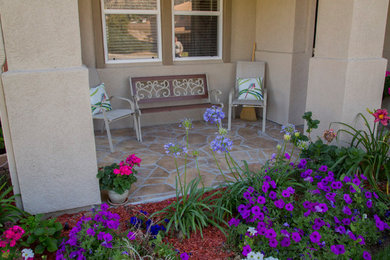 Inspiration for a mid-sized stone front porch remodel in Los Angeles with a roof extension