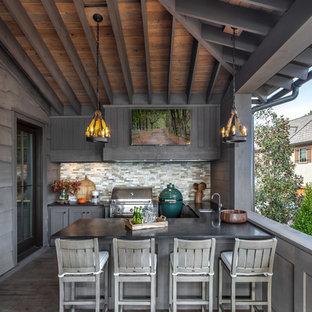 This is an example of a transitional outdoor kitchen porch design in Atlanta with decking and a roof extension.