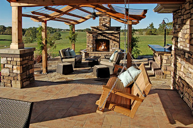 Large arts and crafts stone back porch photo in Chicago with a fire pit and a pergola