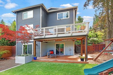 This is an example of a mid-sized contemporary back porch design in Seattle.
