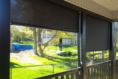 This is an example of a small classic screened veranda in Toronto with decking.