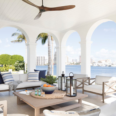 Beach style tile porch photo in Miami with a roof extension