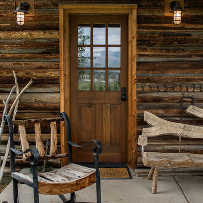 Mid-sized mountain style front porch photo in Other with decking and a roof extension