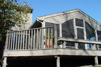 Inspiration for a large transitional screened-in back porch remodel in Cincinnati with decking and a roof extension