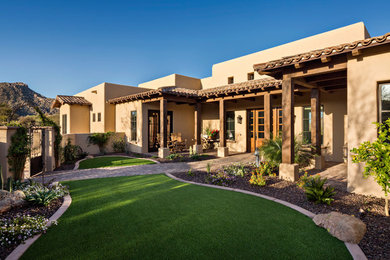 Mid-sized elegant concrete paver porch photo in Phoenix with a roof extension