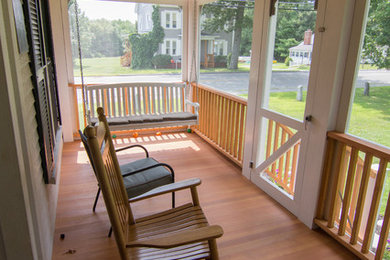 Small elegant screened-in front porch photo in Boston with a roof extension