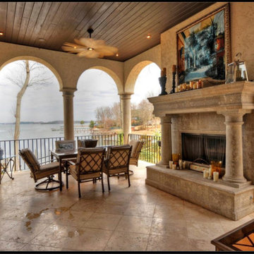porch with limestone fireplace and arches