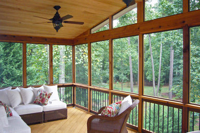 This is an example of a mid-sized traditional back porch design in Atlanta with a fire pit and a roof extension.