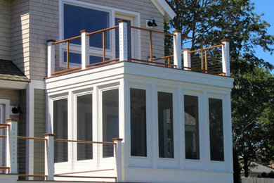 This is an example of a small traditional back porch design in Boston.