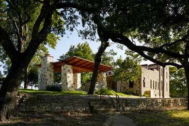 Mid-sized mountain style concrete porch idea in Austin with a roof extension