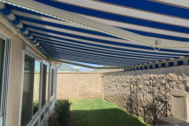 Mid-sized trendy back porch idea in Orlando with an awning