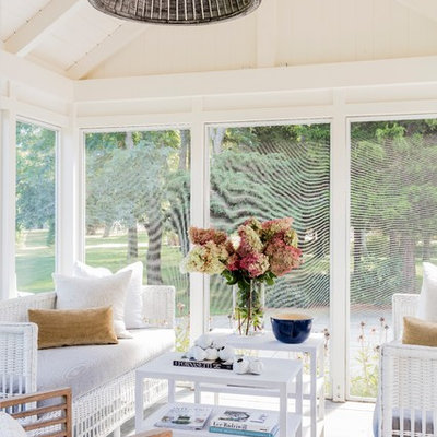 Beach style stone screened-in side porch idea in Boston with a roof extension