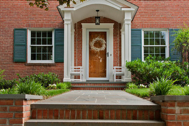 Small elegant tile front porch photo in DC Metro with a roof extension