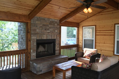 Large mountain style screened-in back porch photo in Other with decking and a roof extension
