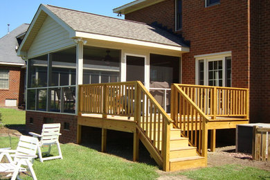 Mid-sized elegant back porch photo in Other with a roof extension