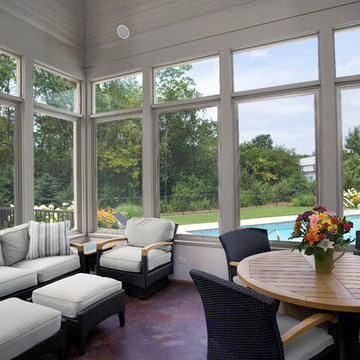 Screened Porch with Stained Concrete Floor and Beadboard Ceiling Overlooks Pool