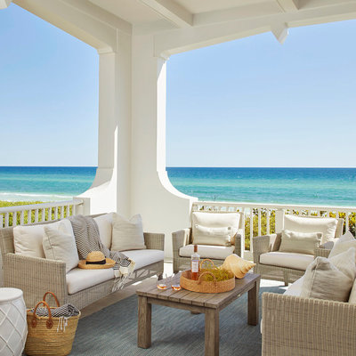 Beach style porch idea in Tampa with a roof extension