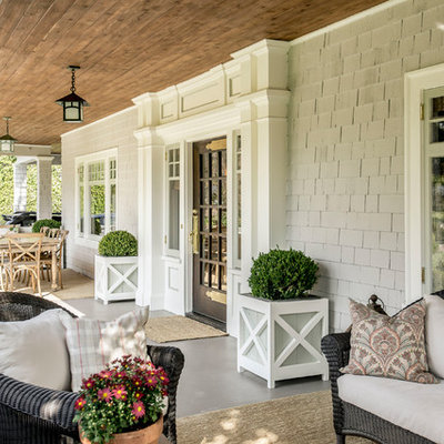 Farmhouse porch container garden idea in Los Angeles with a roof extension