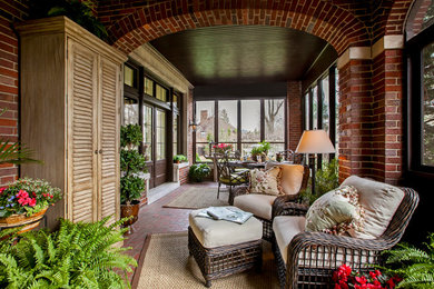 Inspiration for a mid-sized timeless brick back porch remodel in Detroit with a roof extension
