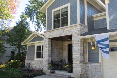 Inspiration for a mid-sized transitional concrete paver porch remodel in Chicago with a roof extension