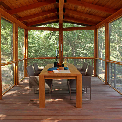Large mountain style screened-in side porch idea in Minneapolis with decking and a roof extension