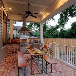 Mid-sized classic brick porch idea in Houston with a roof extension