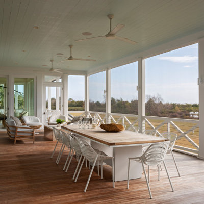 Large beach style back porch photo in Charleston with a roof extension