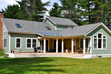 Mid-sized transitional front porch idea in Burlington with a roof extension