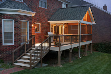 This is an example of a mid-sized traditional back porch design in Charlotte with decking and a roof extension.