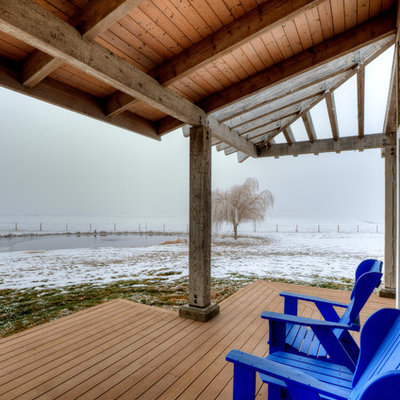 This is an example of a mid-sized farmhouse side porch design in Seattle with decking and a roof extension.