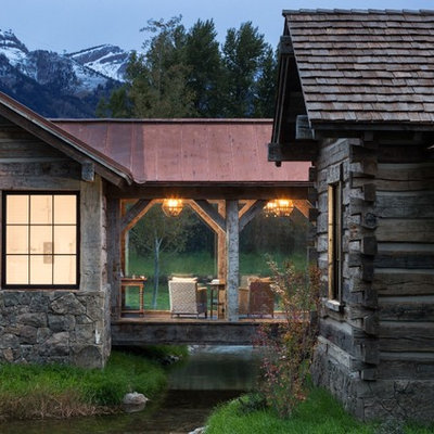 Mountain style side porch photo in Other with a roof extension