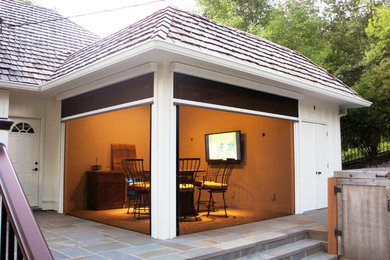 Inspiration for a small classic back screened veranda in Minneapolis with natural stone paving and a roof extension.