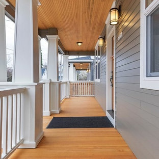 Foto di un portico stile americano davanti casa con pedane e un tetto a sbalzo