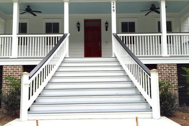 Inspiration for a large timeless front porch remodel in Charleston with a roof extension