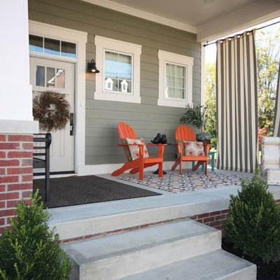 Arts and crafts concrete front porch idea in Indianapolis with a roof extension