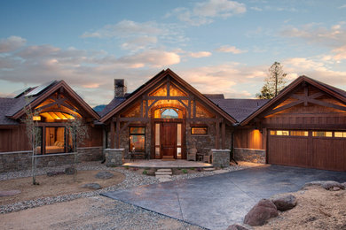 Mid-sized mountain style stone front porch idea in Denver with a roof extension